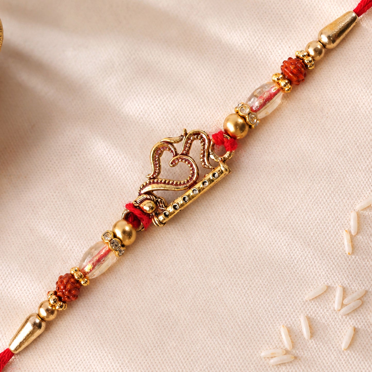 Om and Flute Pendant Rakhi with Rudraksha Beads