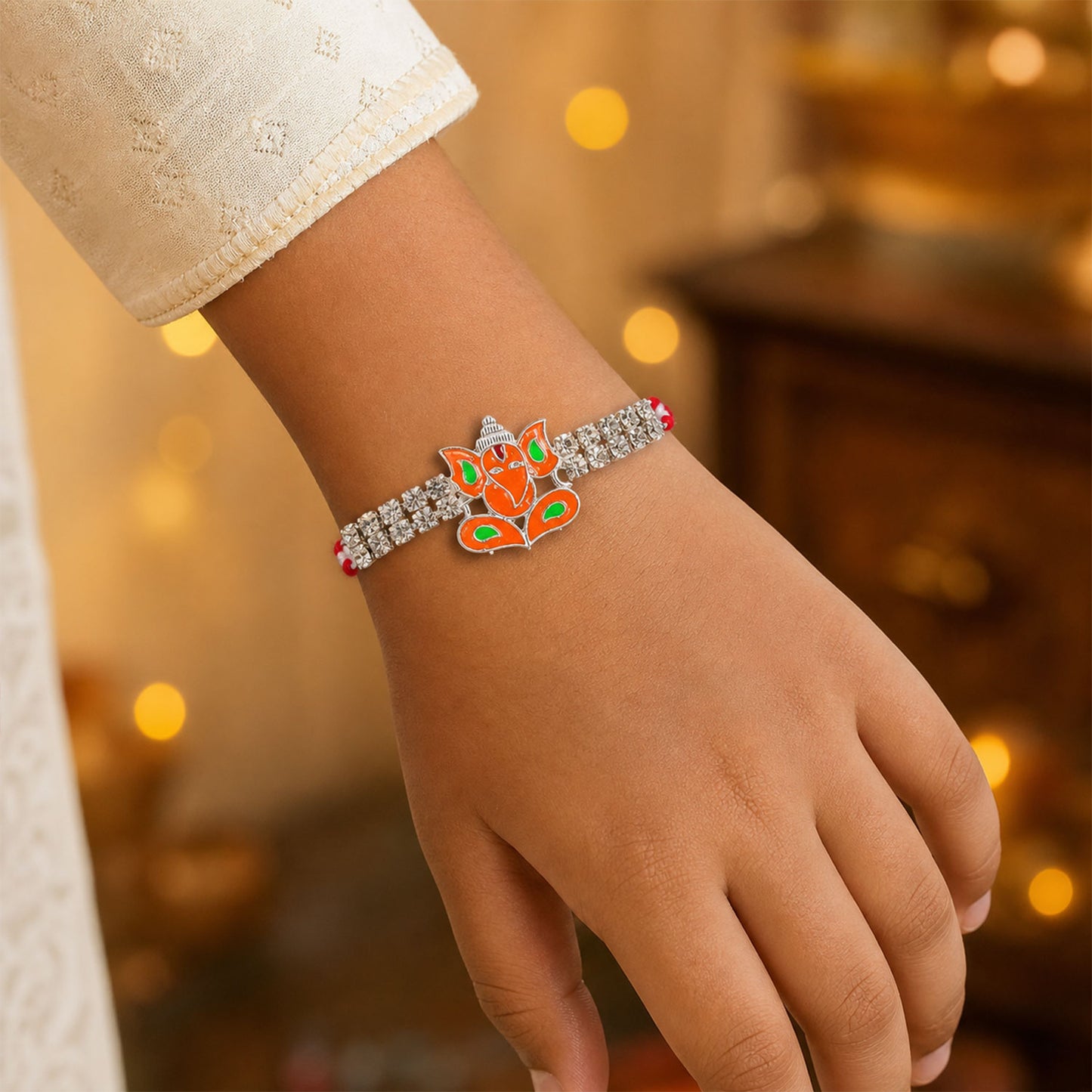 Silver-Toned Lord Ganesha Rakhi with Orange-Green Enamel, Double Crystal Chain & Red Thread