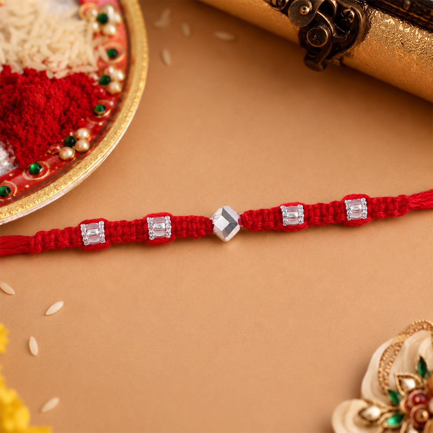 Red Thread Rakhi with Silver Square Beads and Diamond-Shaped Charm