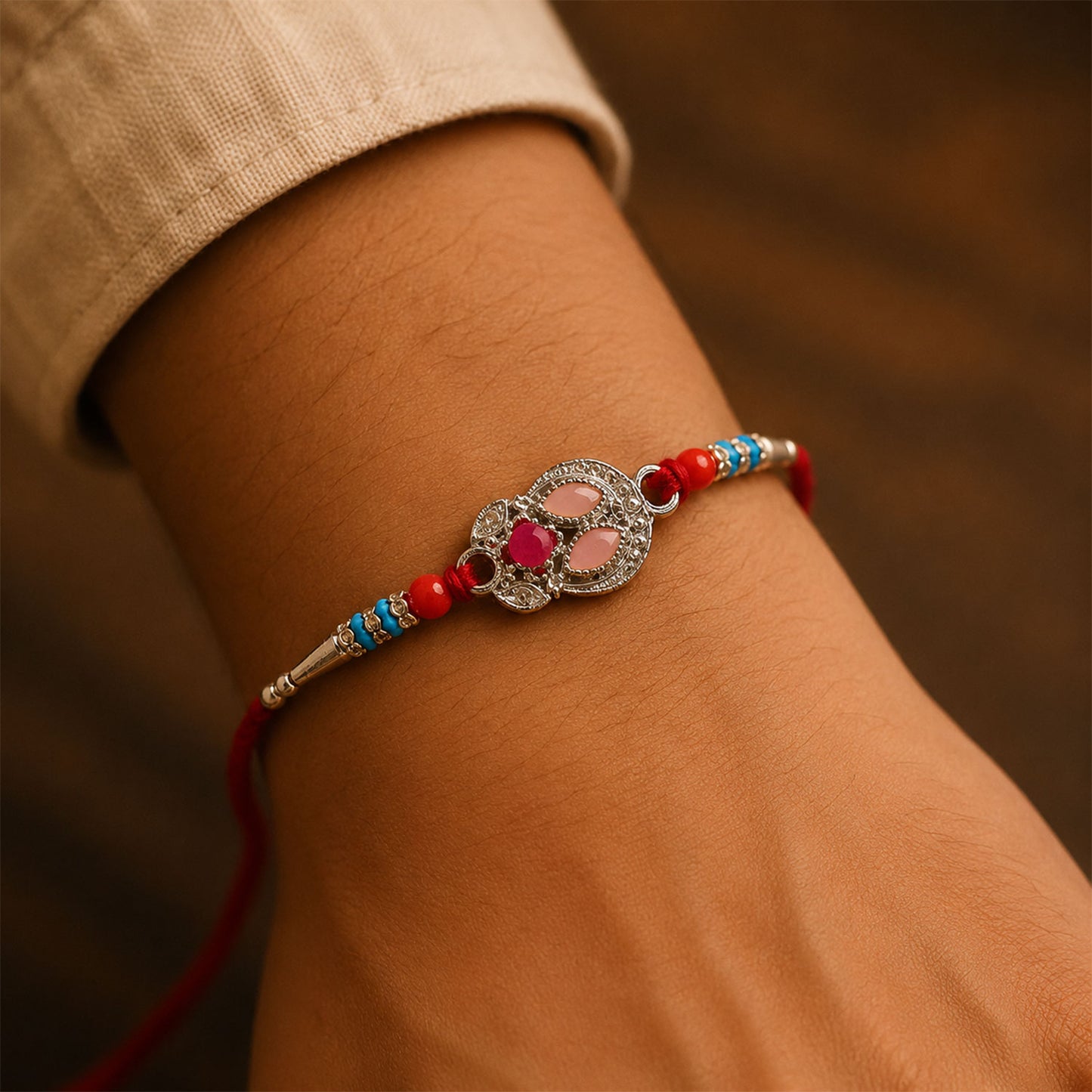 Oval Pink Stone Filigree Rakhi with Red Thread, Roli Chawal Coin and Gift Box Packing