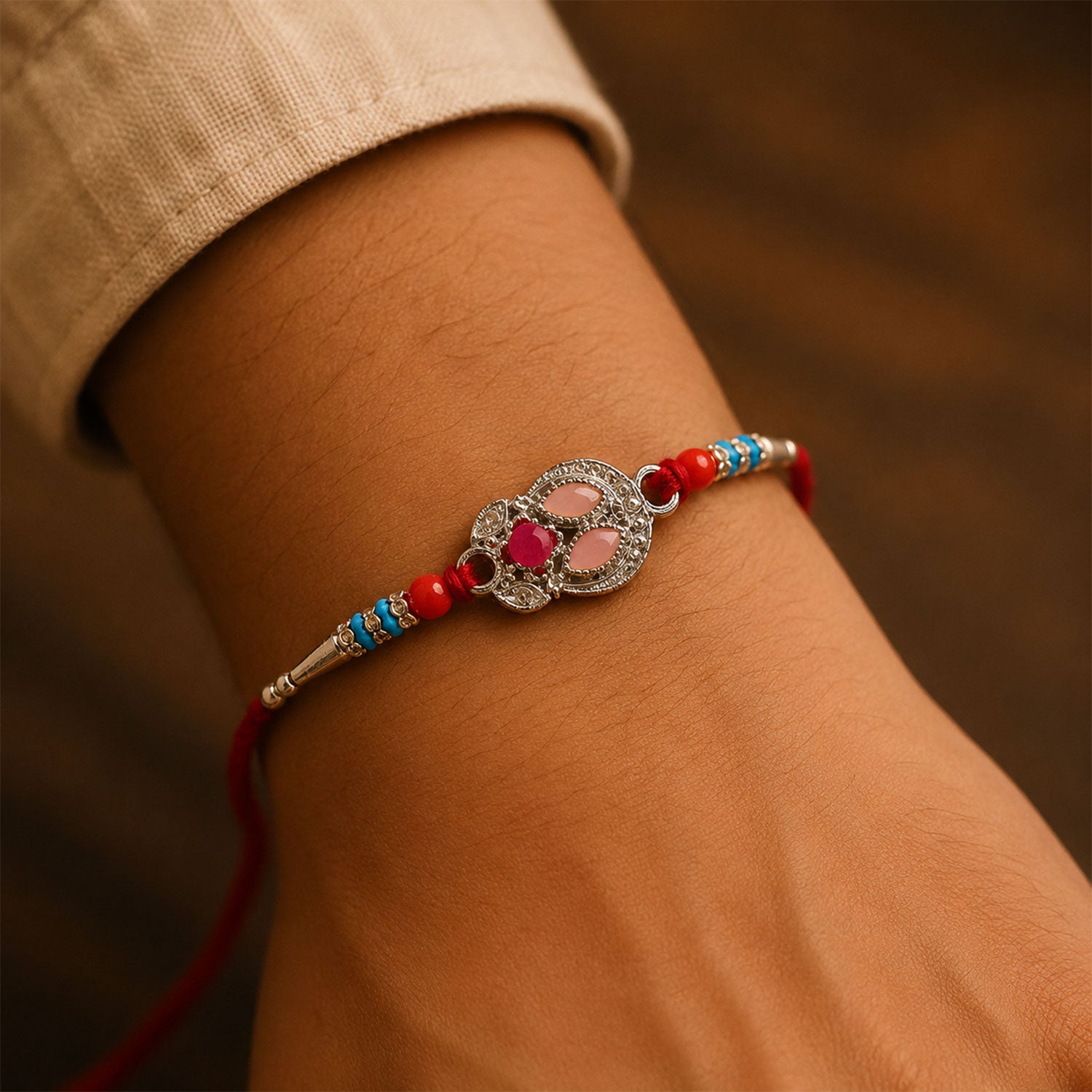Oval Pink Stone Filigree Rakhi with Red Thread, Roli Chawal Coin and Gift Box Packing