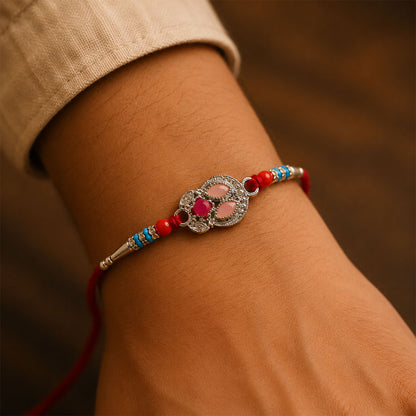Oval Pink Stone Filigree Rakhi with Red Thread, Roli Chawal Coin and Gift Box Packing