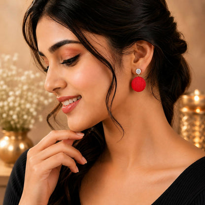 Detail shot of several colorful drop earrings, emphasizing the intricate designs and sparkling crystal elements.