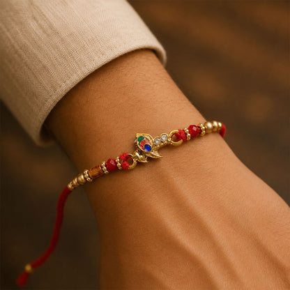 Peacock Floral Crescent Rakhi with Antique Gold Centre, Color Stones and Red Thread