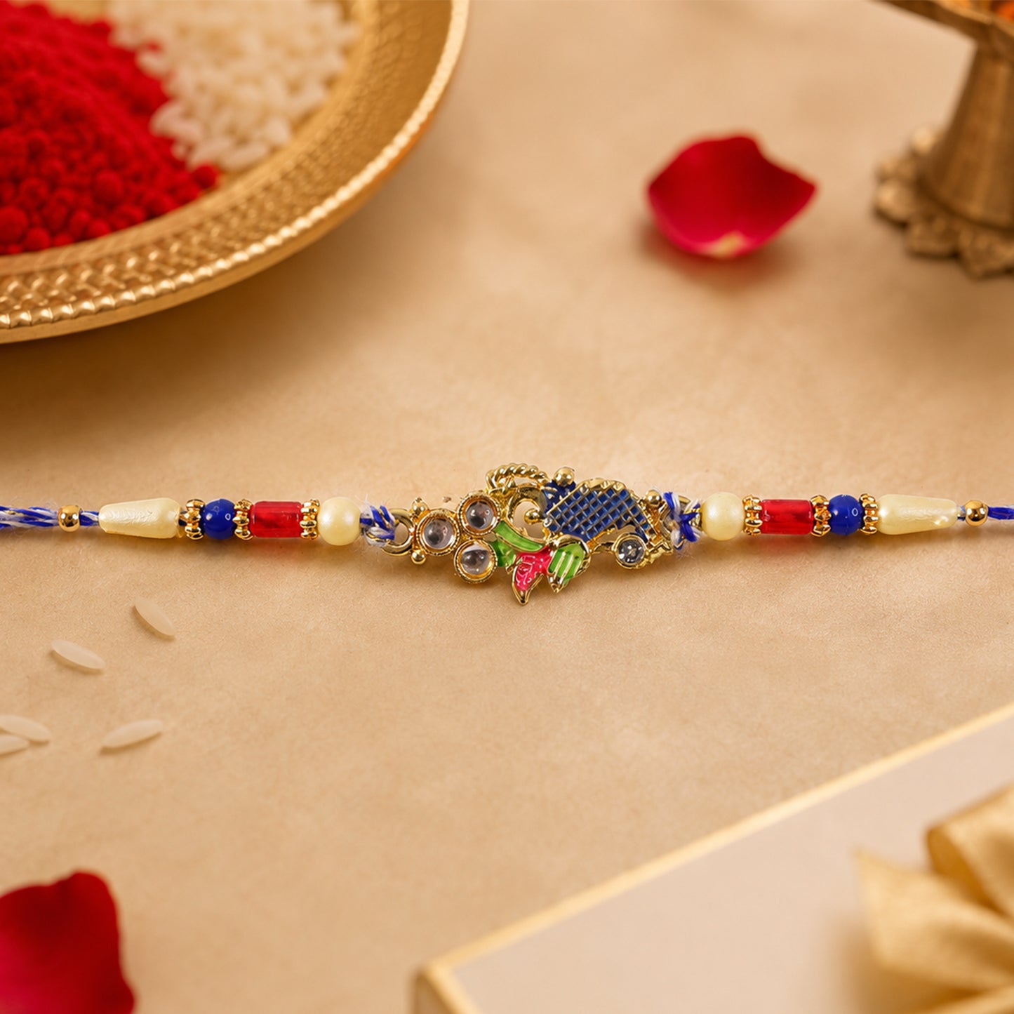 Peacock Motif Rakhi with Red Blue Beads and Elegant Traditional Gift Presentation