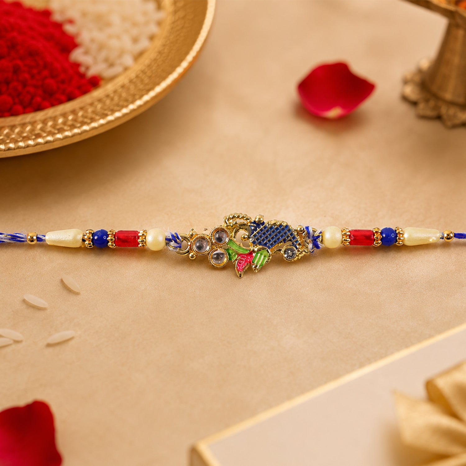 Peacock Motif Rakhi with Red Blue Beads and Elegant Traditional Gift Presentation