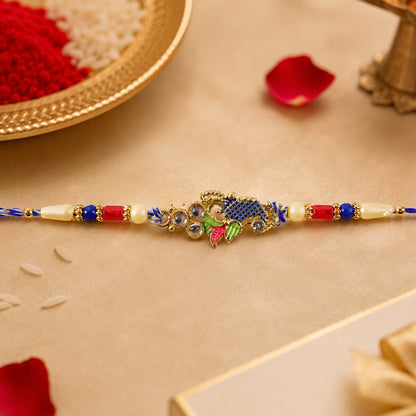 Peacock Motif Rakhi with Red Blue Beads and Elegant Traditional Gift Presentation