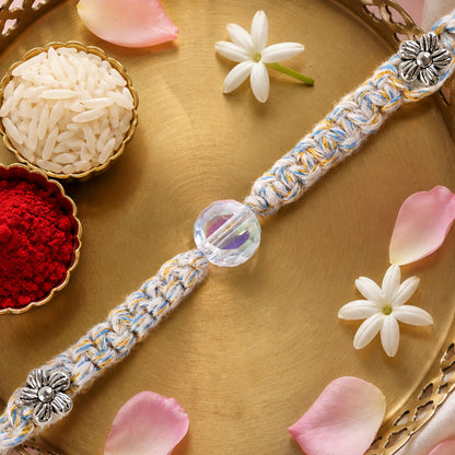 Pastel Braided Rakhi with Blue-White Thread and Crystal Bead Charm for Raksha Bandhan
