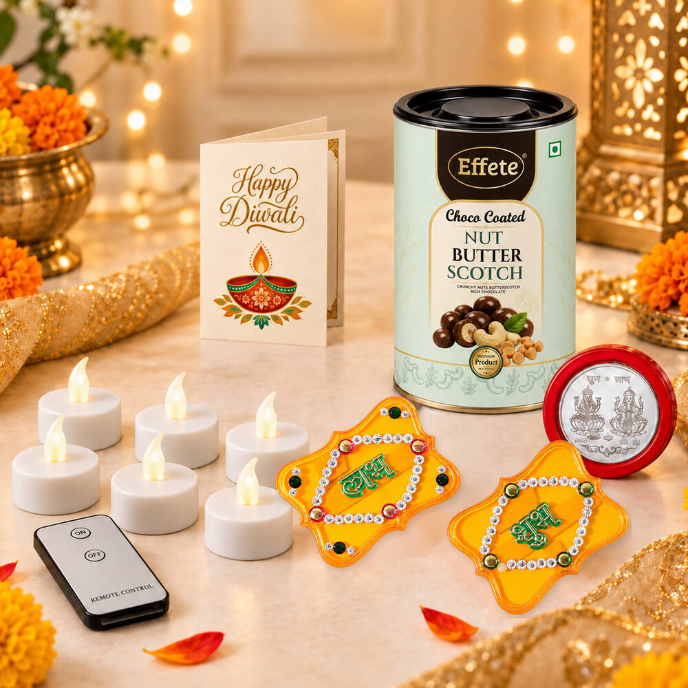 A festive arrangement with a tin of nut butterscotch, a Diwali greeting card, several LED tealights, and two yellow