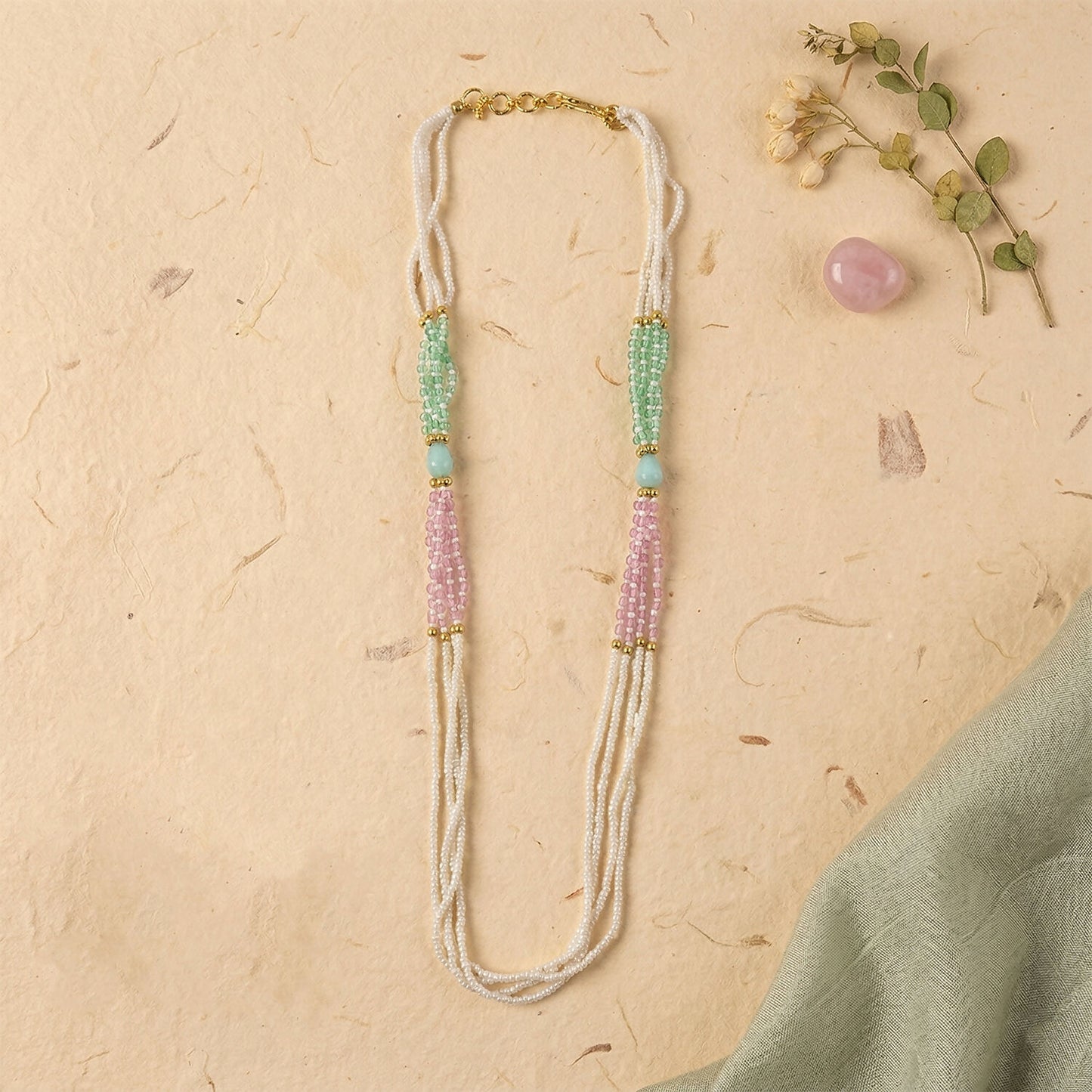 Soft pastel green and pink bead accents on pearl mala necklace