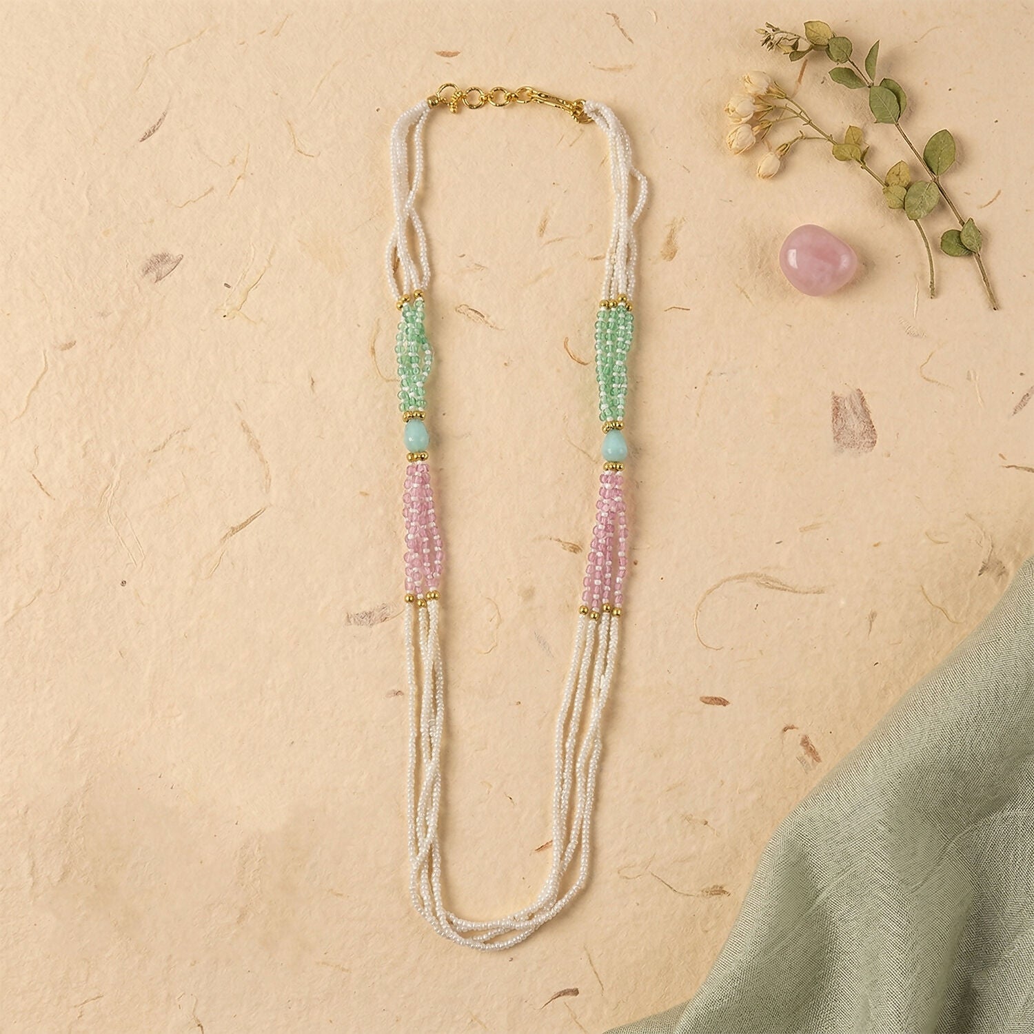 Soft pastel green and pink bead accents on pearl mala necklace