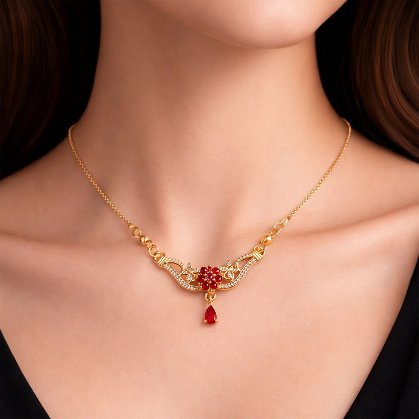 Side angle of gold finish floral pendant necklace with red stone