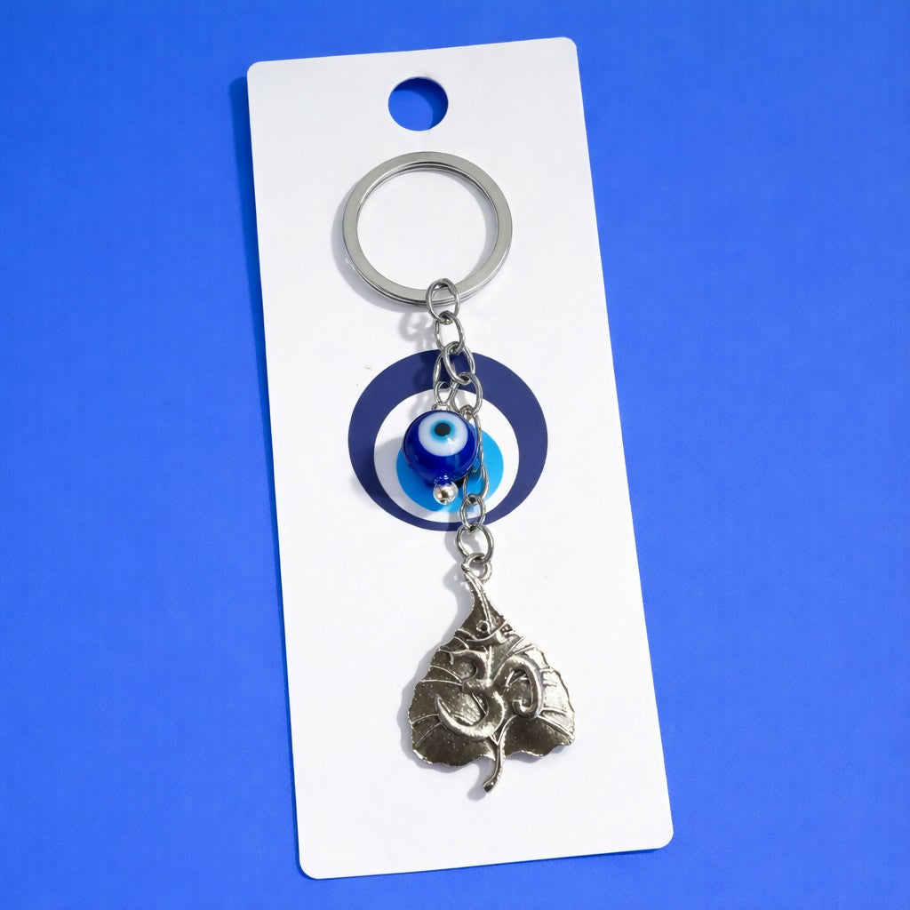 Close-up of Om symbol engraved on leaf keychain