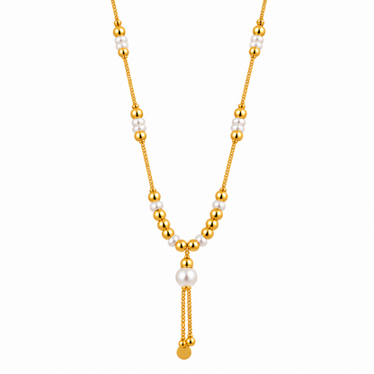 A gold tone necklace with white pearls and gold beads on a plain white background.