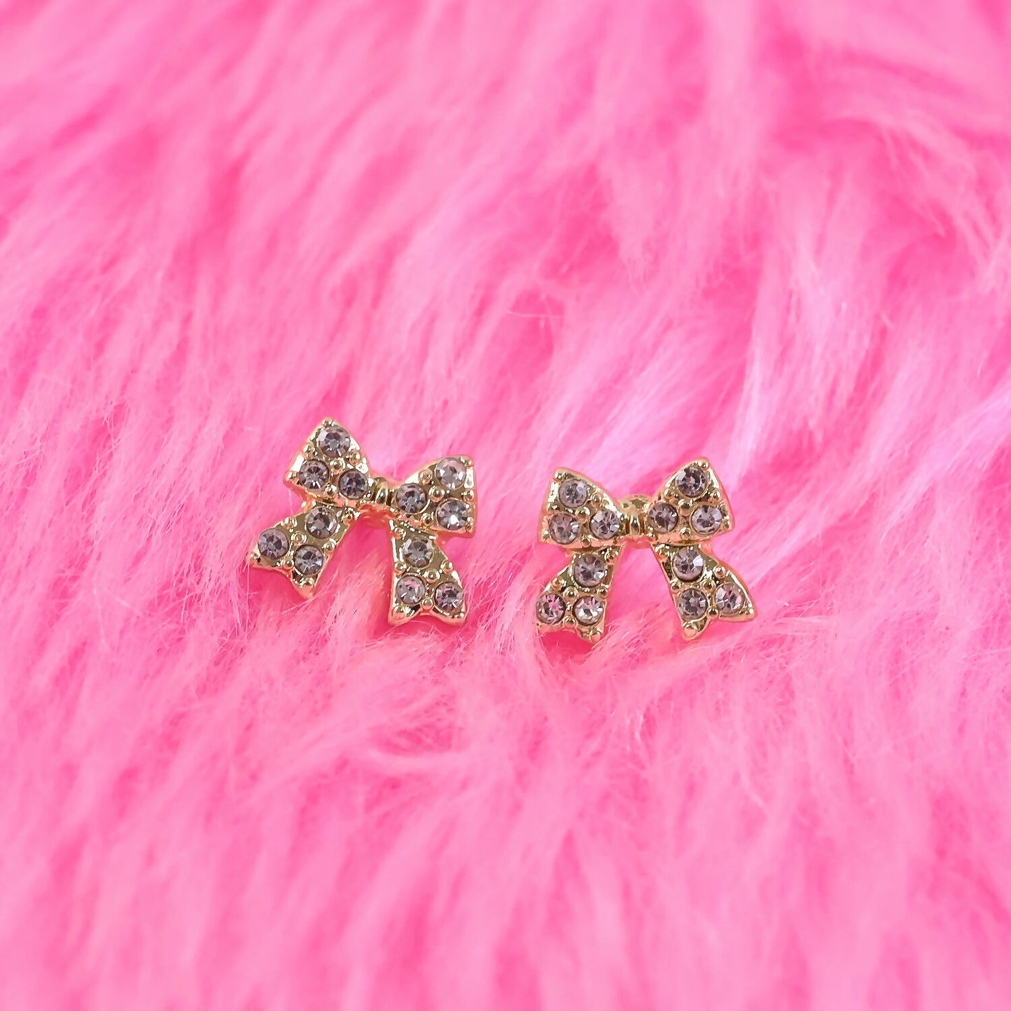 Side view of gold plated crystal ribbon stud earrings