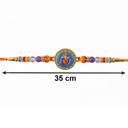 Side view of Lord Ganesha decorative Rakhi on soft thread
