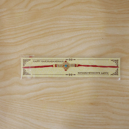 Blue Center Floral Kundan Rakhi with Red Stones and Pearl Ends