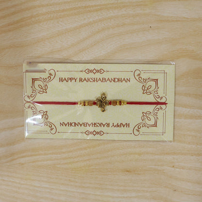 Krishna Flute Idol Devotional Rakhi with Golden Centre, Wooden Beads and Red Thread