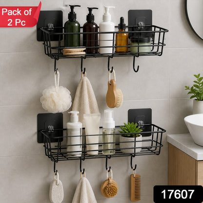 Two black metal wall-mounted storage baskets with hooks, filled with various bathroom products and hanging items, with a
