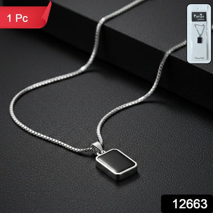 Close-up of black rectangular pendant on men's stainless-steel chain