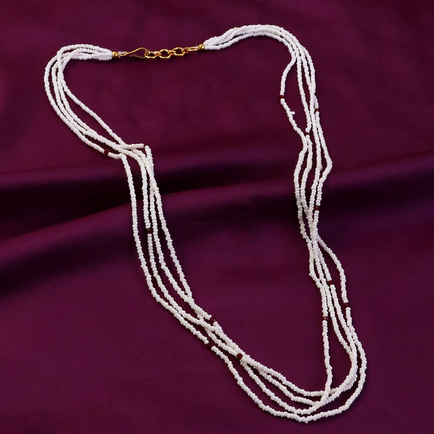 Side view of elegant white beaded mala necklace