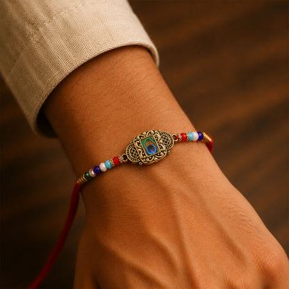 Antique Gold Blue Peacock Stone Designer Rakhi with Multicolor Beads, Roli Chawal Coin and Diya Packing