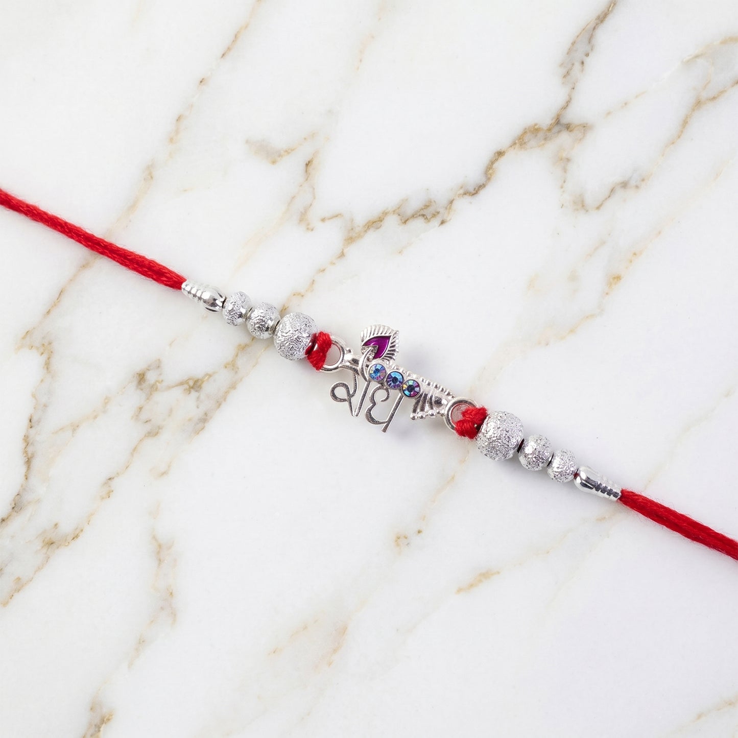 Elegant Radhe Silver Rakhi with Decorative Beads and Red Thread