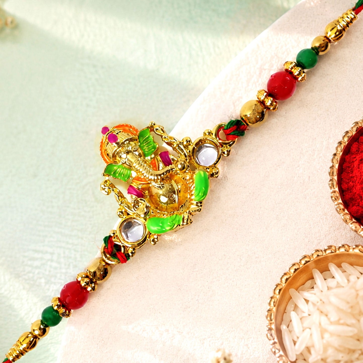 Colorful Ganesh Rakhi with Red Green Beads and Auspicious Festive Gifting Appeal