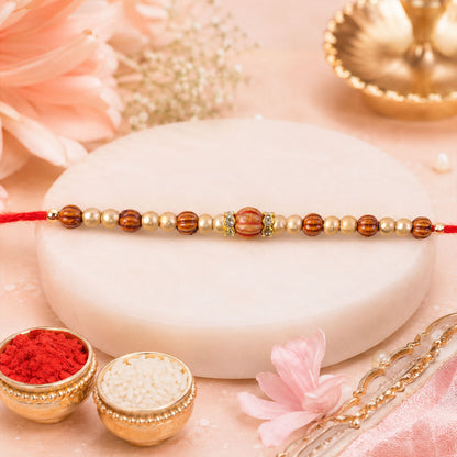 Red Thread Rakhi with Wooden Bead Pendant and Golden Bead Accents