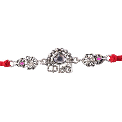 Silver-Toned Kanha Rakhi with Kundan-Style Stone, Crystal Accents & Designer Red Thread