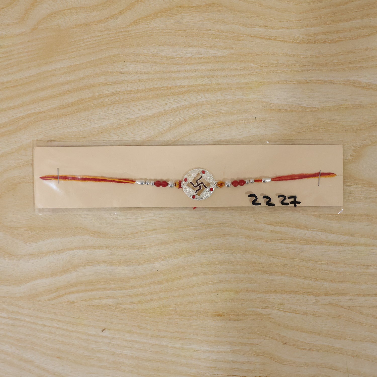 Silver Swastik Stone Rakhi with Red Thread and Handmade Look