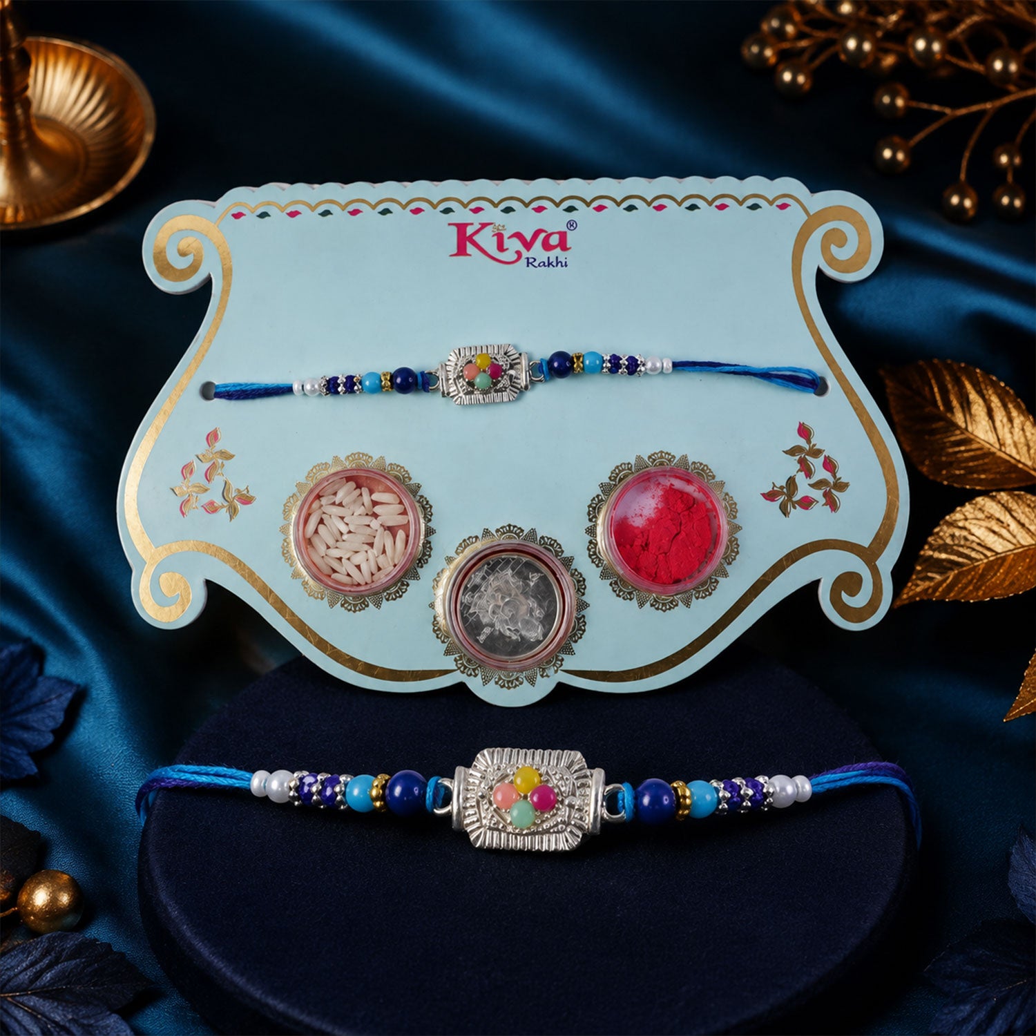 Silver Floral Stone Rakhi with Royal Blue Thread, Roli Chawal Coin and Card Gift Packing