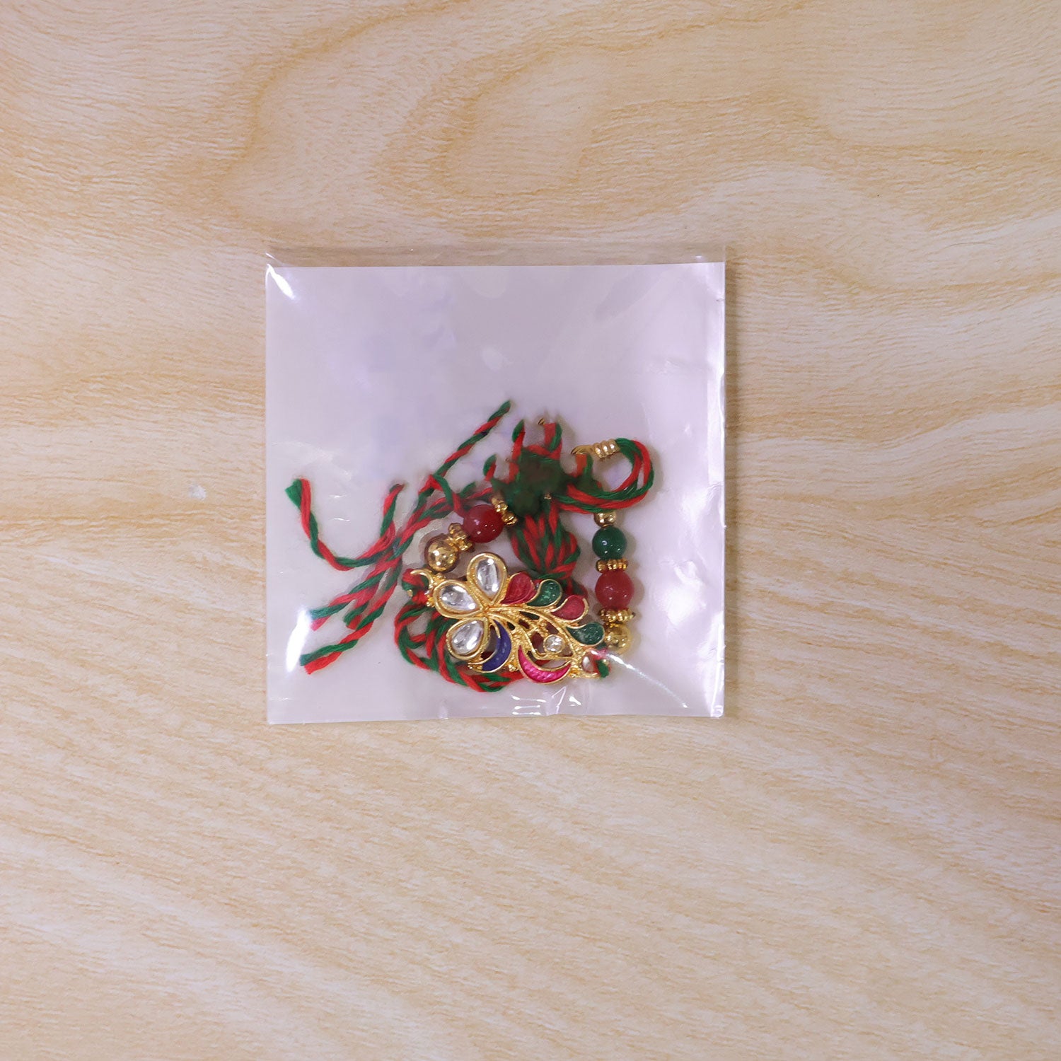 Multicolor Floral Kundan Pendant Rakhi with Green Beads