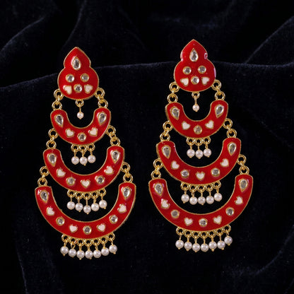 Side view of red layered chandbali earrings with pearl details
