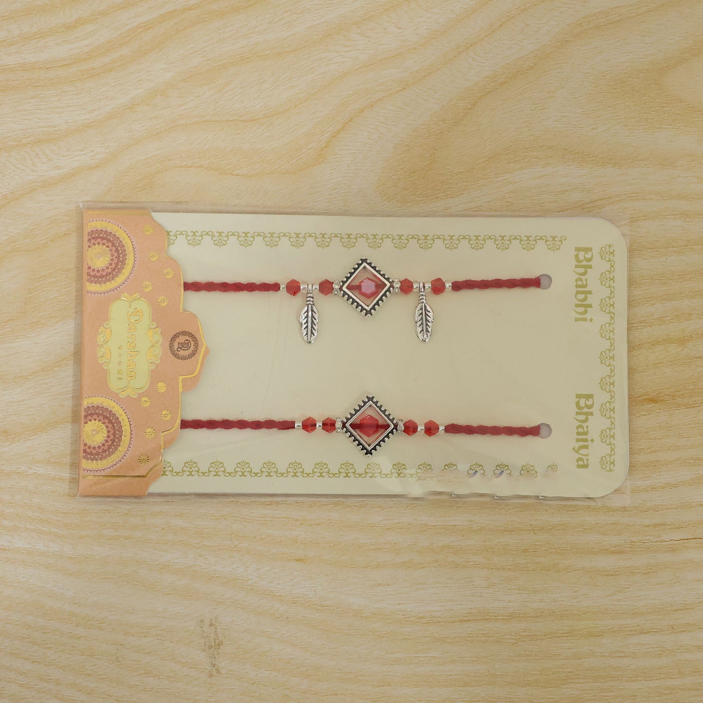 Red Gem Square Rakhi Set with Silver Bead Border and Leaf Charms for Couple Gift