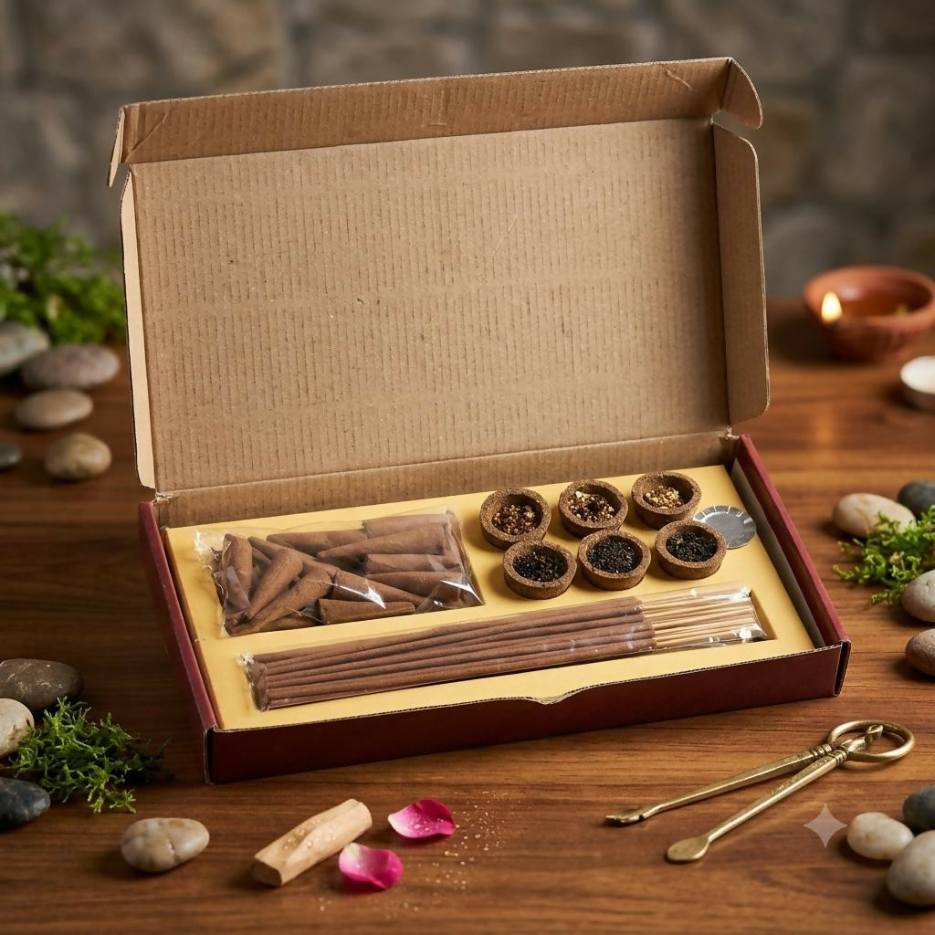An open brown box revealing compartments of dhoop cones, sambrani cups, and incense sticks on a wooden surface.
