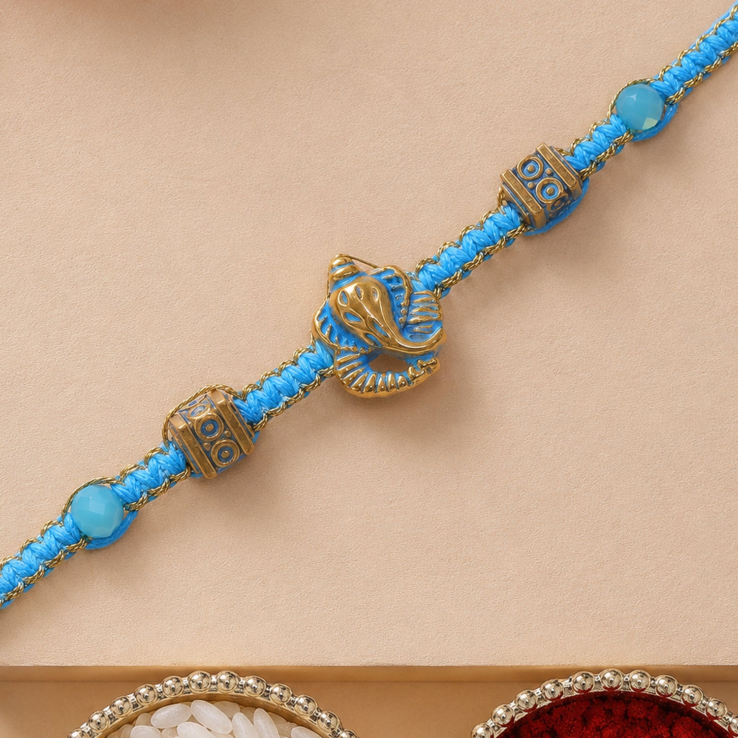 Turquoise Center Designer Rakhi with Gold Tone Detail and Elegant Bracelet Beauty