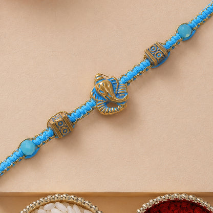 Turquoise Center Designer Rakhi with Gold Tone Detail and Elegant Bracelet Beauty