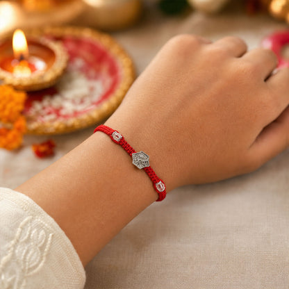 Red Thread Rakhi with Engraved Silver Shield-Shaped Charm Pendant