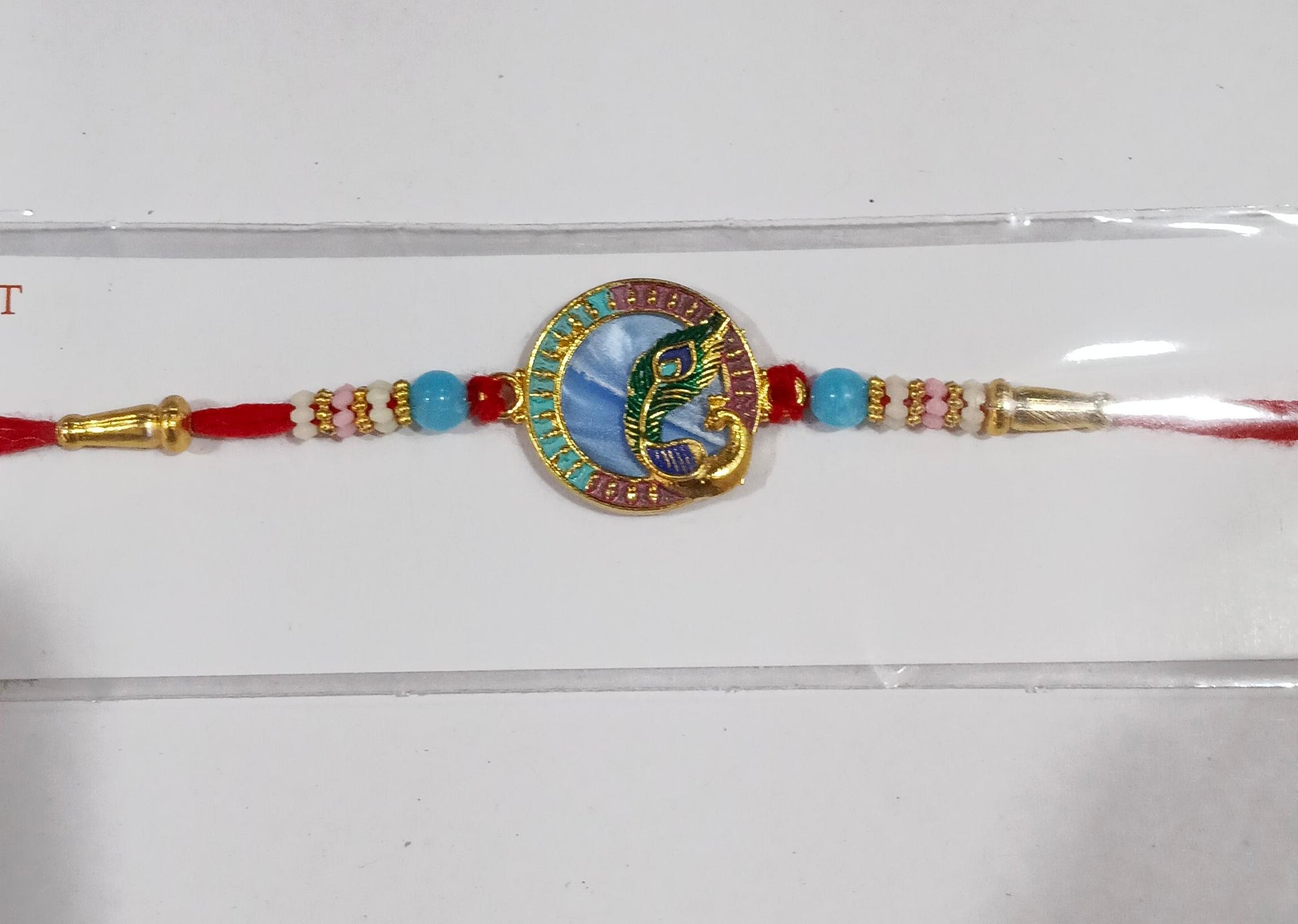 Peacock motif Rakhi with beads in vibrant colors