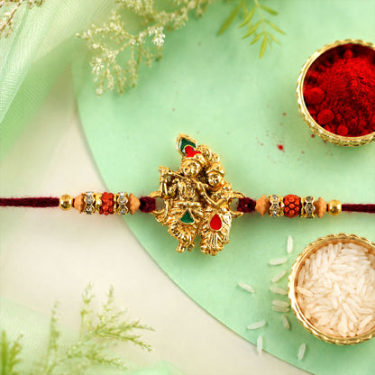 Radha Krishna Golden Devotional Rakhi with Couple Idol Centre and Color Stones