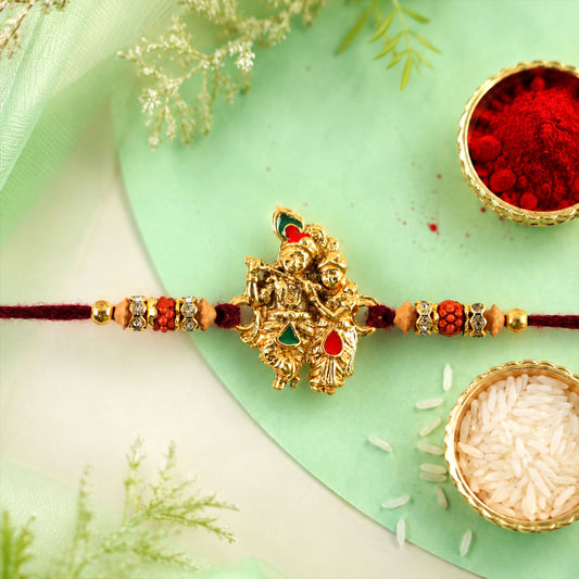 Radha Krishna golden devotional rakhi with couple idol centre