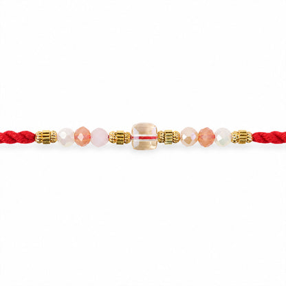 Red Thread Rakhi with Peach and Rose-Toned Crystal Bead Pendant