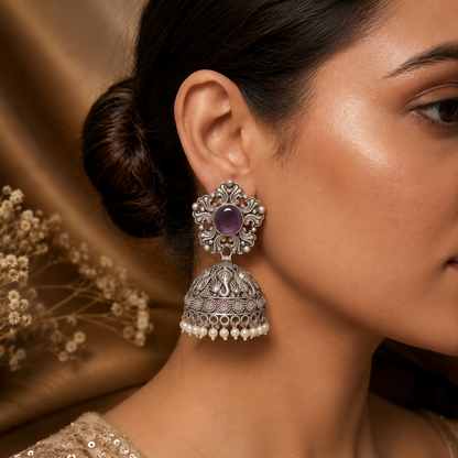Detail of intricate vintage design on oxidized silver jhumka earrings