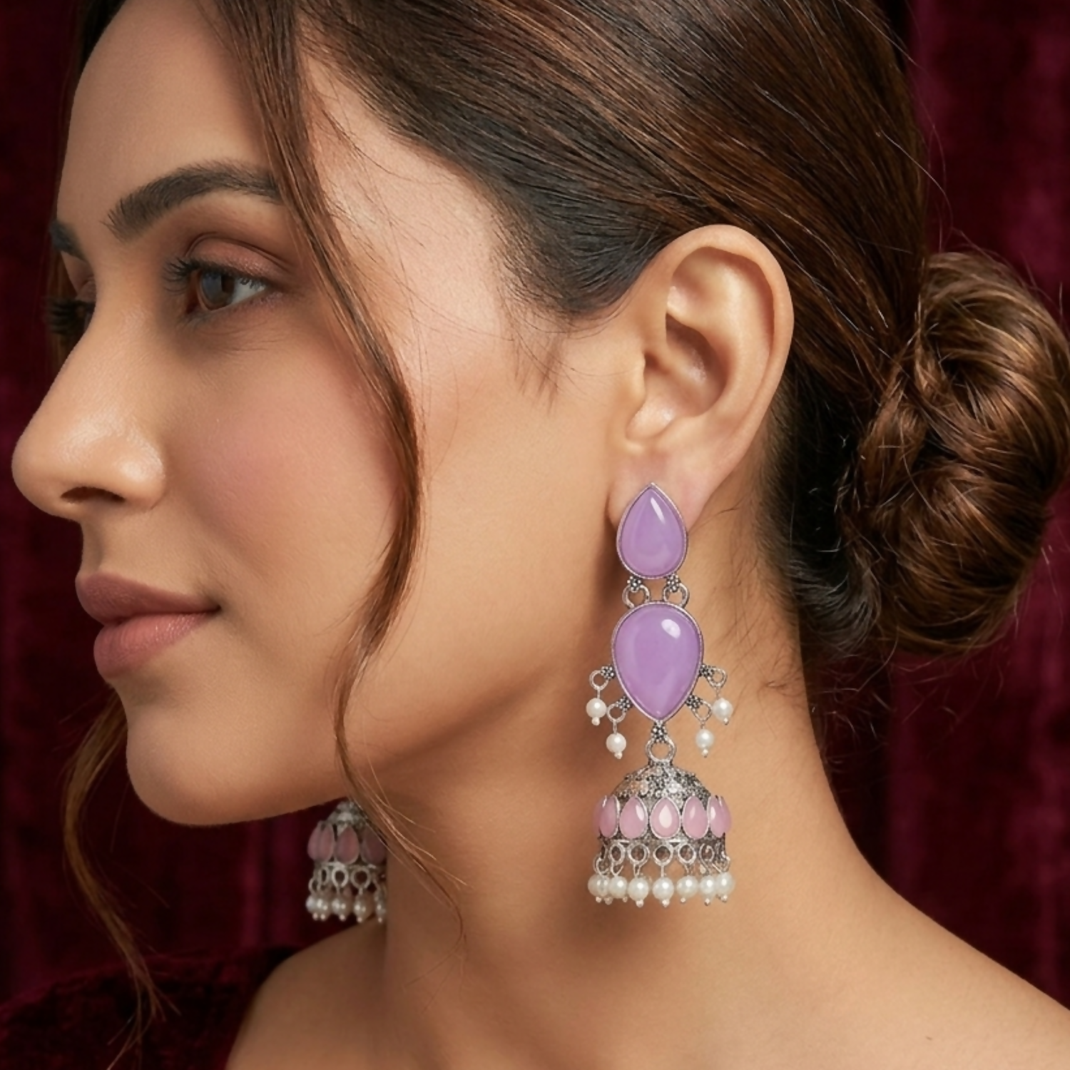 Close-up of oxidized silver Jhumka earrings showing detailed elephant engravings