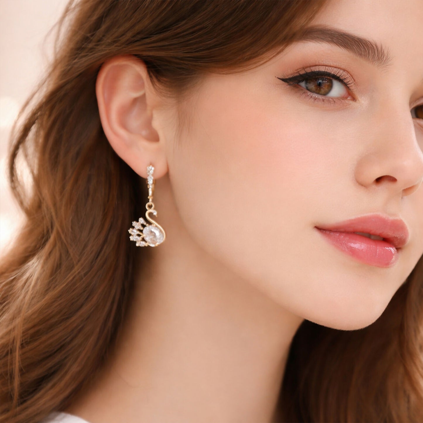 Close-up image of elegant swan motif drop earrings with sparkling stones