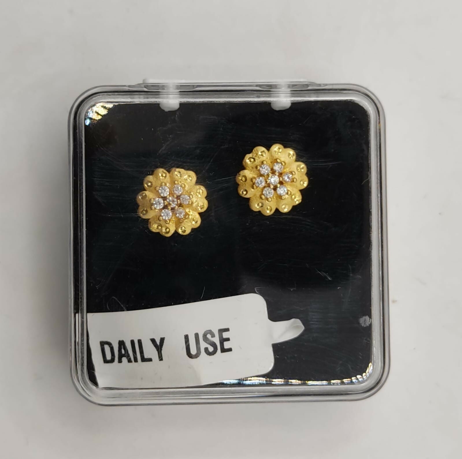 Stylish gold plated small floral stud earrings with 22K finish and CZ stones