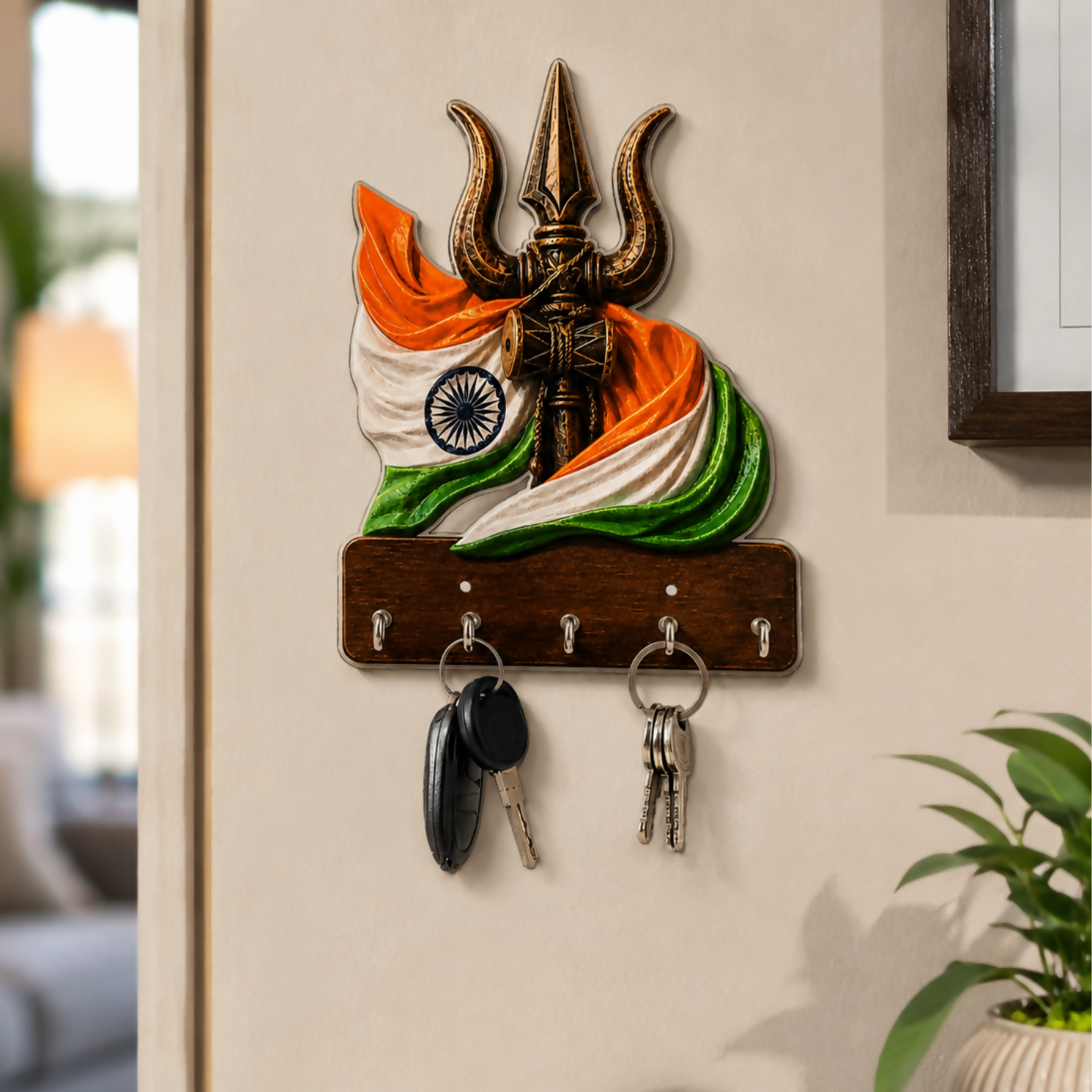 Trishul design wooden key holder with 5 metal hooks on a wall