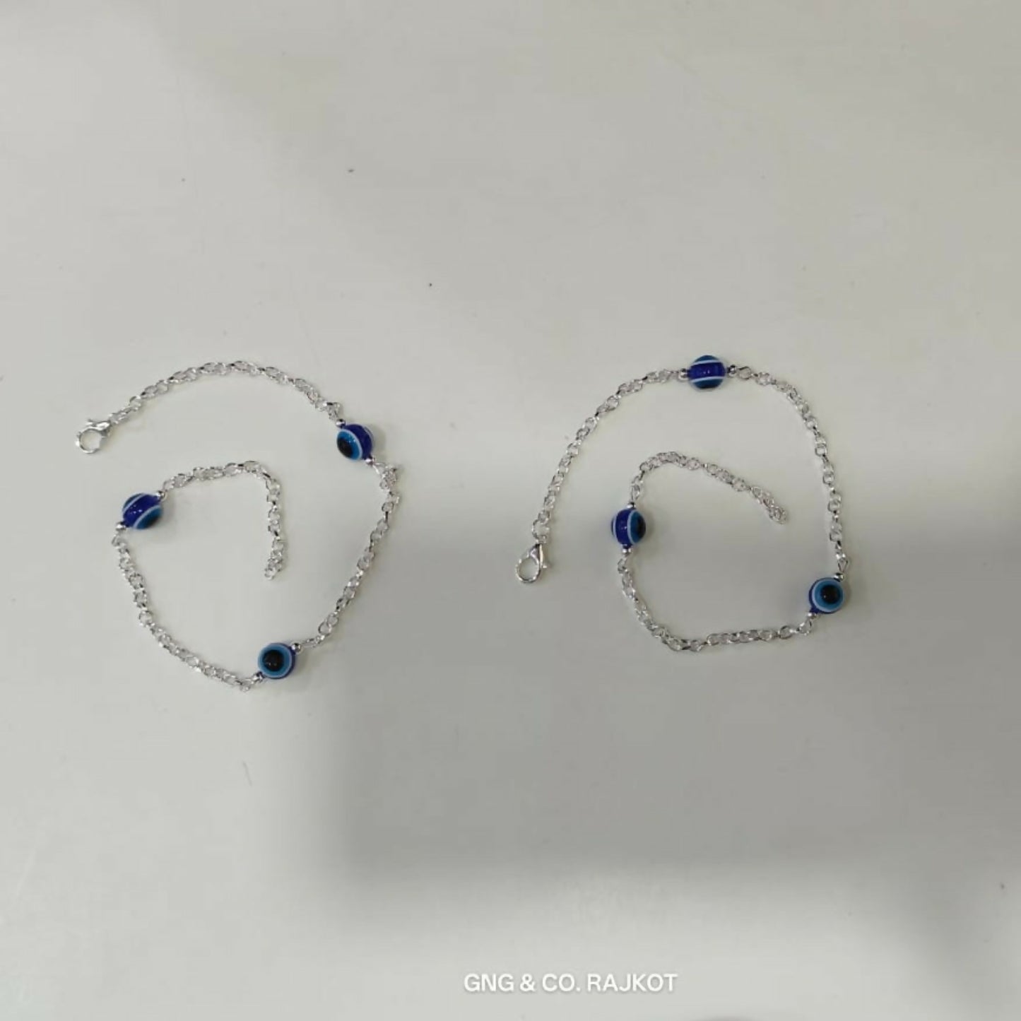 Model Wearing Silver-Plated Evil Eye Anklet Pair