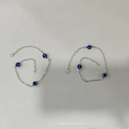 Model Wearing Silver-Plated Evil Eye Anklet Pair